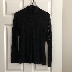 Chico’s black lace turtleneck with attached under garment.  See thru sleeves